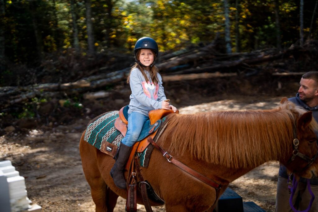 A little girl riding a pony in Rhode Island